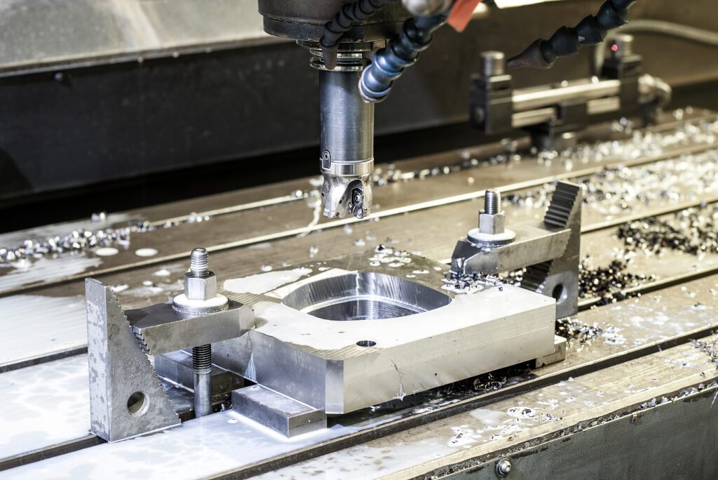 Precision industrial CNC machining of metal detail by mill at factory